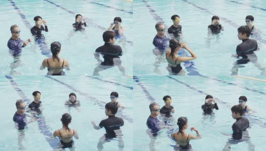 亚洲华人游泳教练在游泳池里教他的学生做准备高清在线视频素材下载