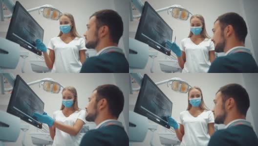 牙科医生戴着手套在牙科诊所的电子屏幕上展示牙齿全景x光片，背景为光，配有医疗设备。微笑健康牙齿概念。高清在线视频素材下载