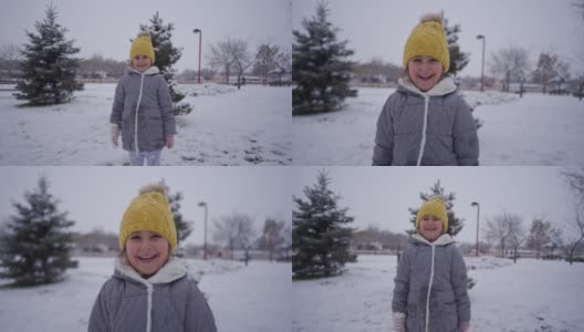 可爱的微笑女孩享受第一天的雪高清在线视频素材下载