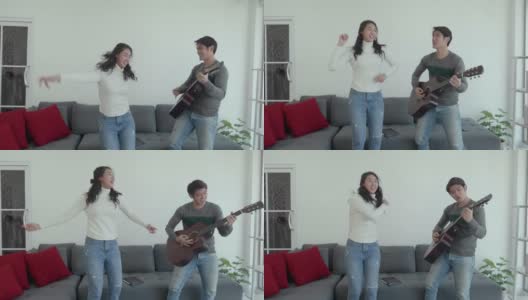 一对亚洲年轻夫妇一起弹吉他跳舞高清在线视频素材下载