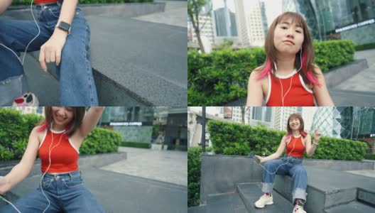 快乐的少女戴着耳机在城市的户外跳舞唱歌高清在线视频素材下载