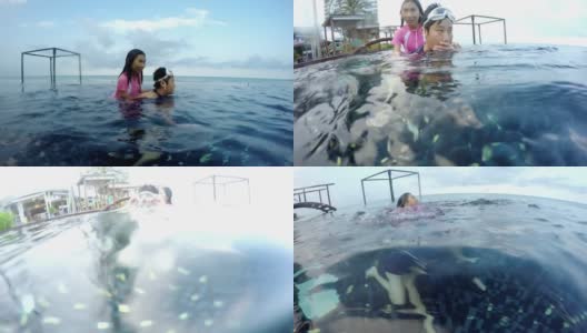 亚洲的孩子们在度假期间与家人一起在酒店的游泳池里放松和戏水，生活方式的概念。高清在线视频素材下载