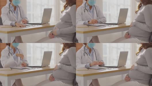 专业的亚洲女医生咨询孕妇，聪明的医生穿着白大褂，带着听诊器在医院与病人交谈，医生和孕妇的概念高清在线视频素材下载