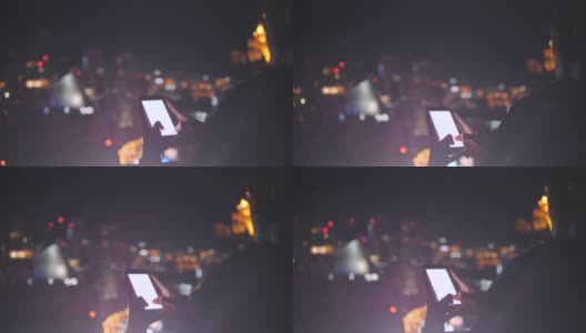 人们在一座建筑上拍摄城市的夜景。高清在线视频素材下载