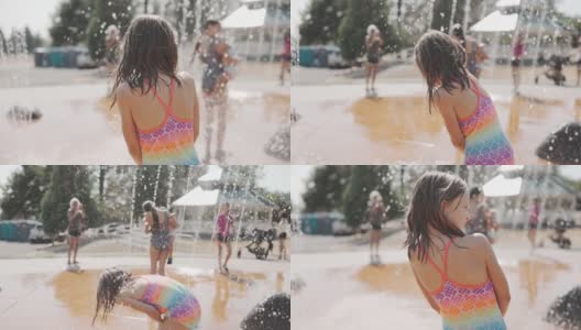 小女孩在水上公园的喷泉里玩高清在线视频素材下载