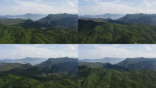 鸟瞰图，绿色的山丘和山脉在蓝天和白云的衬托下高清在线视频素材下载