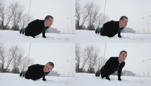 在雪地里做俯卧撑的男人高清在线视频素材下载