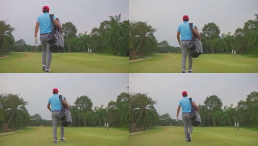 一名亚洲男子高尔夫球手步行和携带高尔夫球袋在高尔夫俱乐部高清在线视频素材下载
