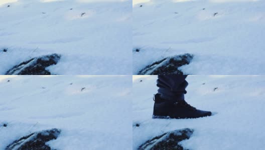 从侧面看，一个人走在雪地上的脚高清在线视频素材下载
