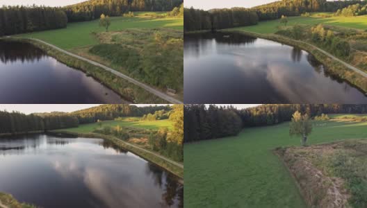 缓慢飞行视频与无人机航空摄影在巴伐利亚森林附近Grafenau向后在水库在大armschlag，德国高清在线视频素材下载