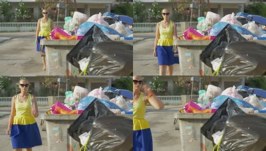 女人把塑料瓶扔进街道垃圾里高清在线视频素材下载