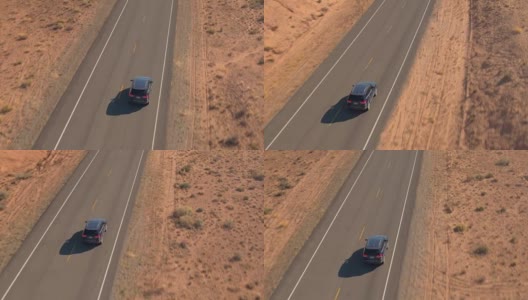 一辆黑色SUV行驶在沙漠中空旷的道路上高清在线视频素材下载