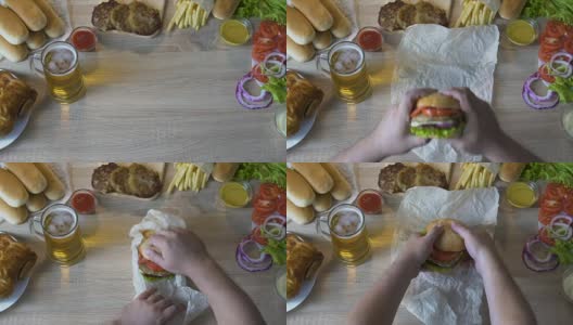 胖男人的手打开新鲜的汉堡，把它送到他的嘴，油腻的食物高清在线视频素材下载