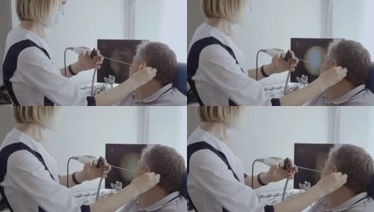 医生用耳鼻喉镜检查病人的耳朵高清在线视频素材下载
