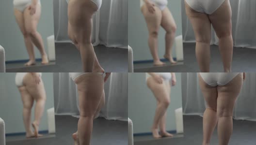 有体重问题的女孩在镜子里看着自己的腿，用手抚摸它们高清在线视频素材下载