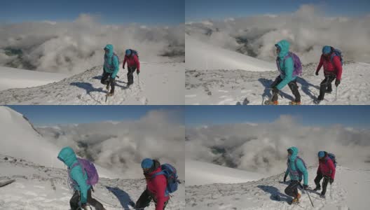 两名女登山家在云上微笑着攀登冰川。高清在线视频素材下载