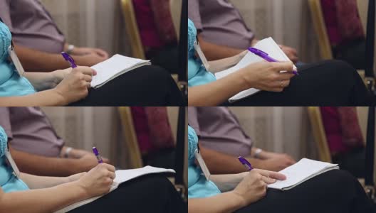 一个女人在笔记本上写字高清在线视频素材下载