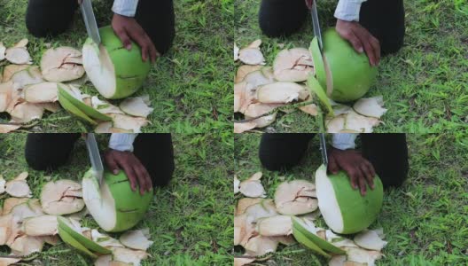 一个人剥一个绿色的大椰子高清在线视频素材下载