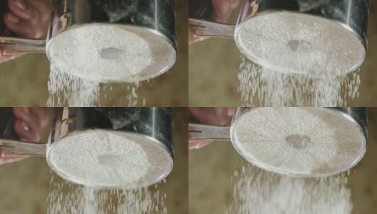 单手面粉筛。面粉颗粒下落高清在线视频素材下载