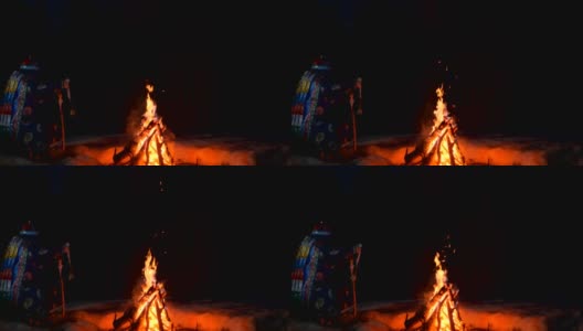 一个萨满坐在火边的剪影。高清在线视频素材下载