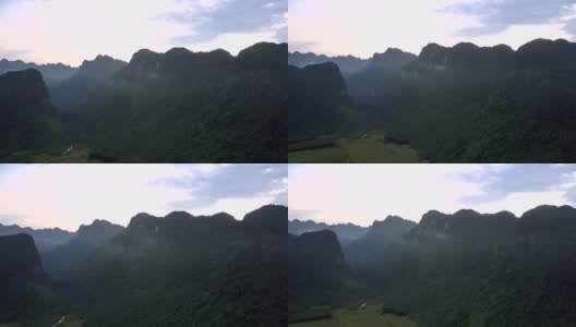 高耸的山脉在灰色的雾和深深的沟壑之间高清在线视频素材下载
