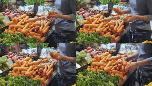 年轻女子购物新鲜蔬菜选择水果在市场。健康的生活方式高清在线视频素材下载