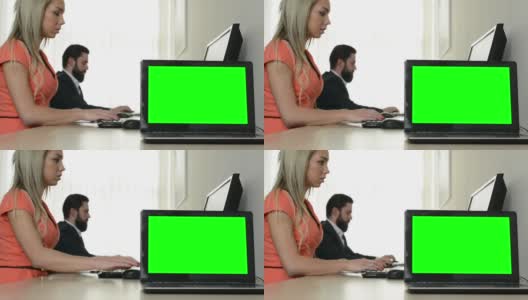 电脑(笔记本电脑)-绿色屏幕-男人和女人工作的电脑在办公室的背景高清在线视频素材下载
