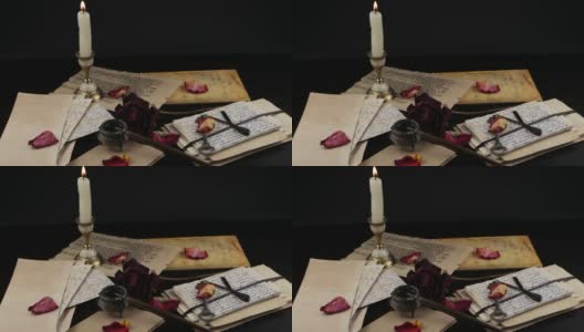 蜡烛，干玫瑰和古老的家族档案高清在线视频素材下载