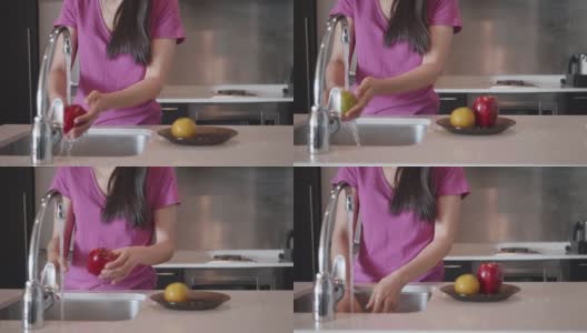 年轻女子在家里的厨房水槽里洗盘子和水果高清在线视频素材下载