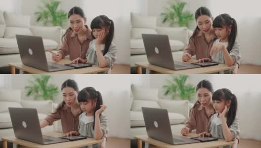 妈妈在家里用笔记本电脑帮助女儿学习高清在线视频素材下载