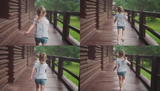 梳着金色辫子的小女孩在空荡荡的阳台上奔跑高清在线视频素材下载