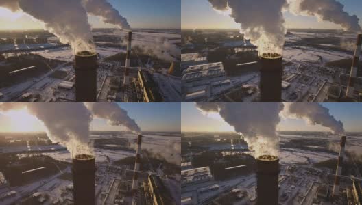 冒烟的烟囱发电厂的背景在冬天日落。鸟瞰图高清在线视频素材下载
