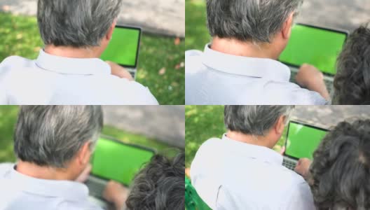 后视图:年长的亚洲夫妇使用笔记本与他们的孩子面对面的时间高清在线视频素材下载