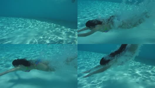 女孩在游泳池里跳跃，水下慢动作高清在线视频素材下载