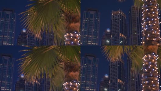 在迪拜码头阿联酋摩天大楼外立面上的夜灯。起重机。高清在线视频素材下载