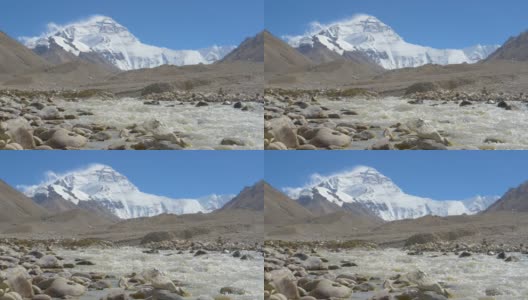 低角度:肮脏的溪流流过白雪覆盖的珠穆朗玛峰的岩石山麓。高清在线视频素材下载