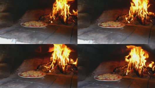 自制美味的马苏里拉奶酪披萨，在粘土烤箱中烹饪，背景是木头火焰。高清在线视频素材下载