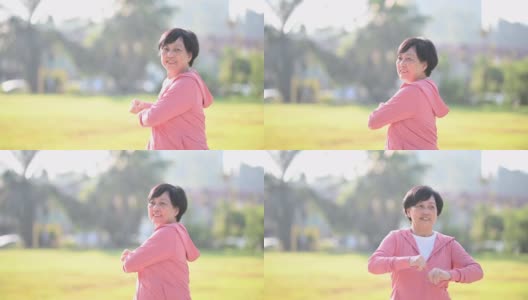 一位亚洲华裔老年妇女早上在公园做热身运动高清在线视频素材下载