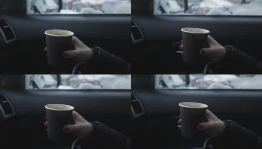 女人在冬天坐在车里喝着热饮高清在线视频素材下载