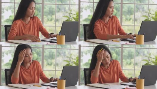 亚洲女性在家工作时，在笔记本电脑前做项目会感到压力。科技生活的新常态高清在线视频素材下载