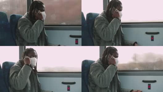 戴面具的非洲人在公共汽车上打电话。他拿着电话，说留言。高清在线视频素材下载