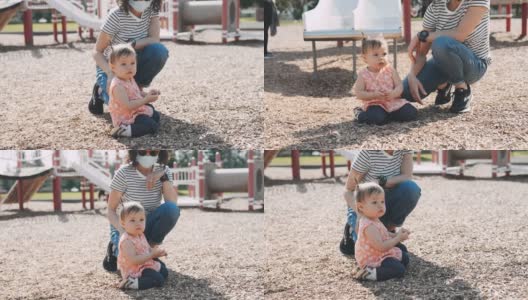 少数民族母亲在公园里和蹒跚学步的女儿玩耍高清在线视频素材下载