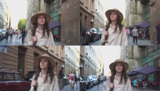 一个戴着帽子的漂亮女孩走过古镇。肖像高清在线视频素材下载