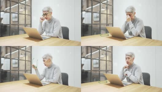 成熟的亚洲女商人戴着眼镜，使用笔记本电脑，坐在办公桌旁。疲惫的50多岁老人坐在办公桌前，脱下眼镜，从笔记本电脑工作中休息，眨眼摩擦鼻梁，减轻眼睛疲劳高清在线视频素材下载