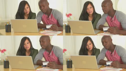 非裔美国人和亚裔夫妇用电脑检查财务状况高清在线视频素材下载