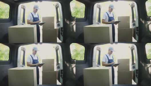 快递员在货车旁边放了一个平板电脑高清在线视频素材下载