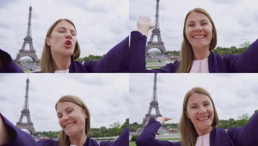 法国巴黎埃菲尔铁塔附近的一名女子正在自拍。微笑的女游客在欧洲旅行高清在线视频素材下载