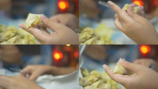 亚洲妇女手工制作馄饨和饺子馅。高清在线视频素材下载