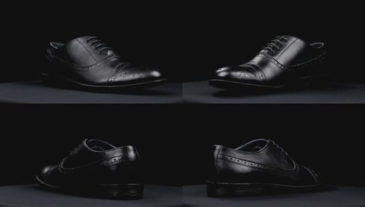 一个时尚的经典黑色鞋与鞋带在黑色的背景旋转。高清在线视频素材下载