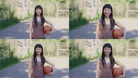 带着球在场上微笑的篮球运动员高清在线视频素材下载
